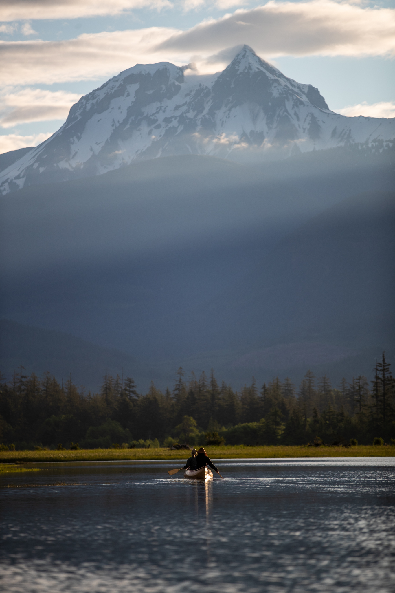Paddler on the calm waters of Howe Sound with snow-capped mountain backdrop near Squamish