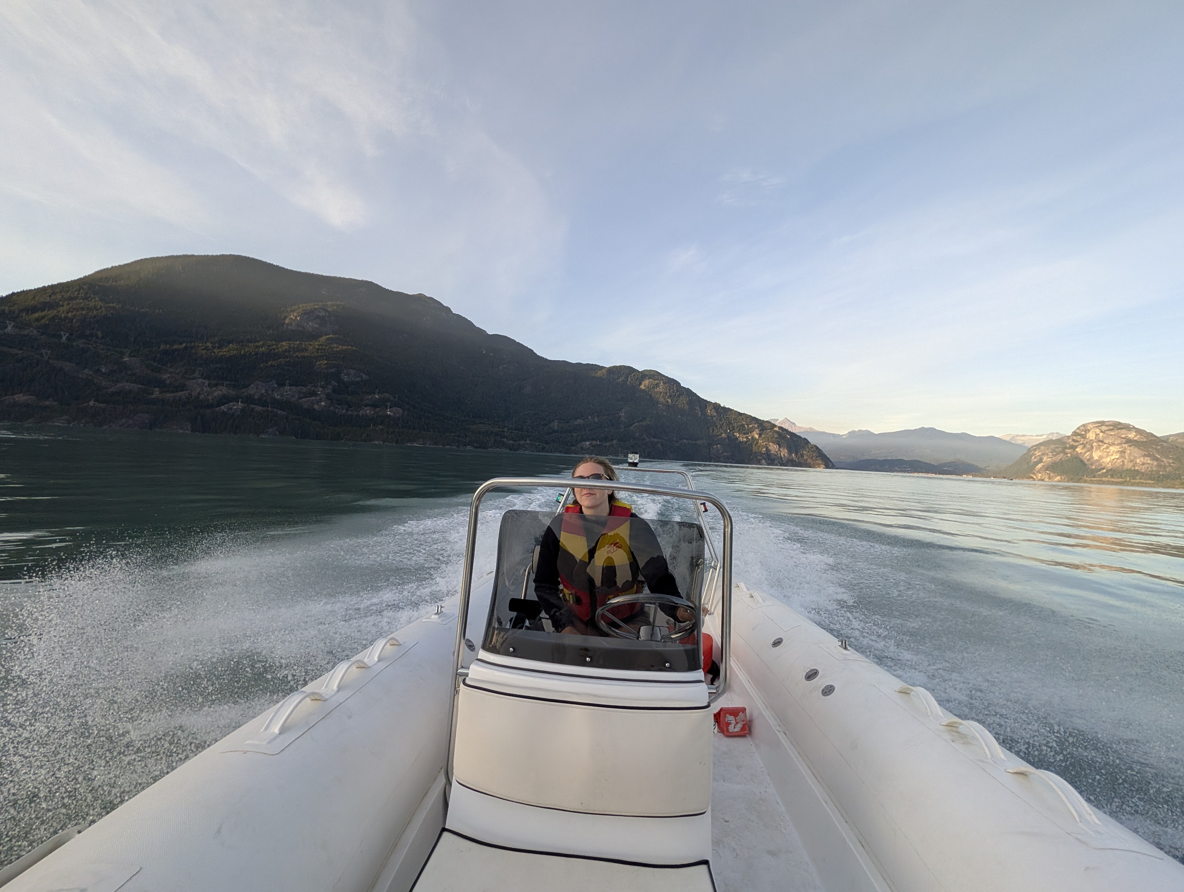 Water taxi boat transporting passengers across Howe Sound near Squamish BC with mountain views